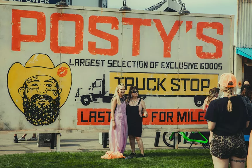 Fans pose for pictures at Post Malone's travelin' tailgate.