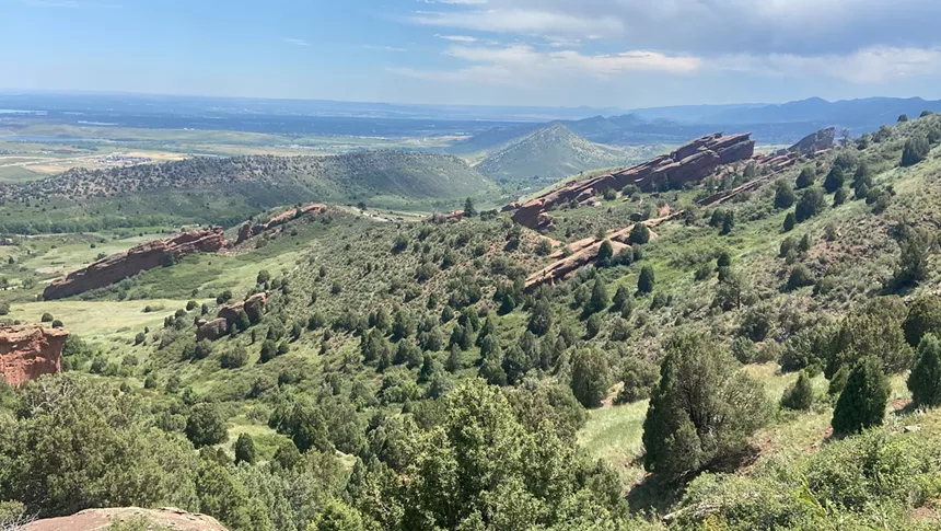 Large rock formations among vegetation at Red Rocks Park