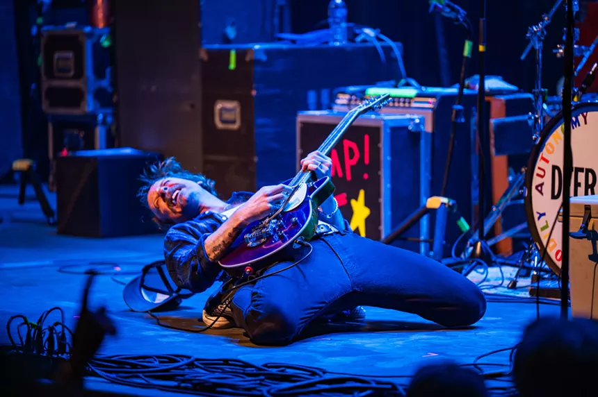John McCauley playing guitar on his knees