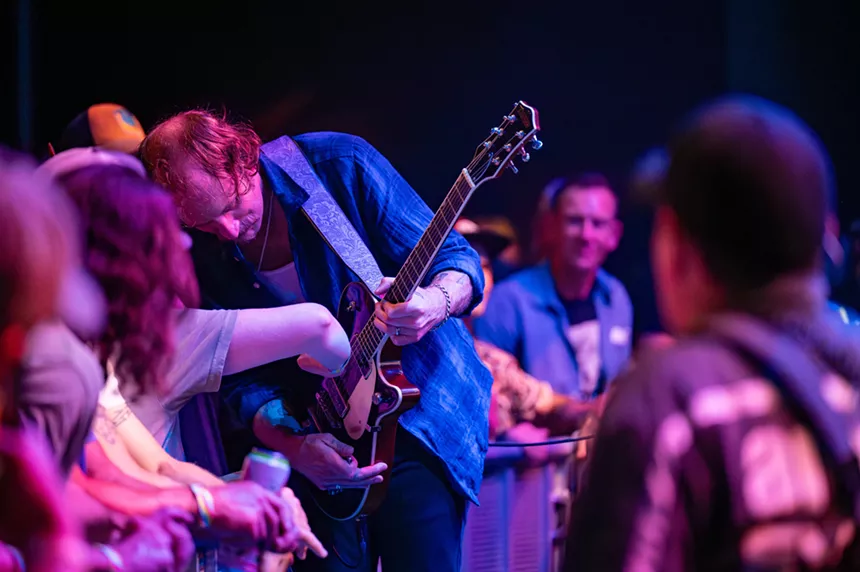 John McCauley letting a fan play his guitar