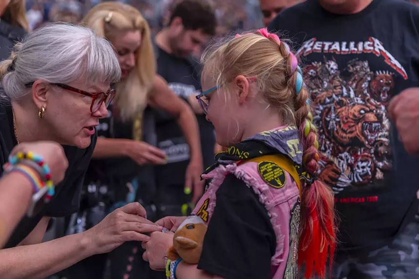 A young Metallica fan was handing out handmade buttons that featured her artwork.
