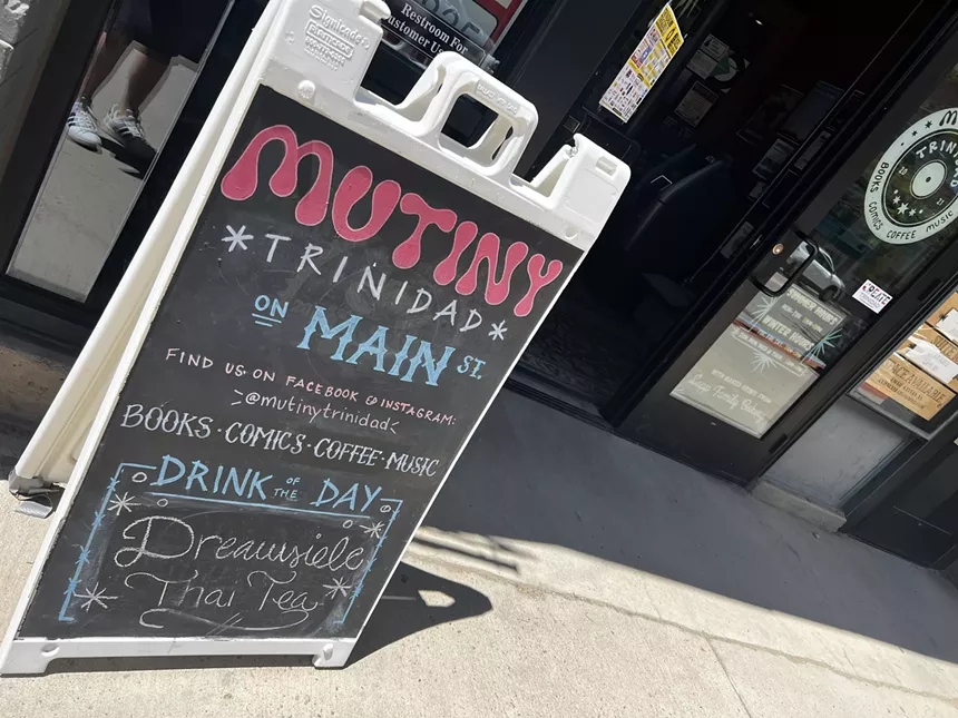 A black sign that says "Mutiny"