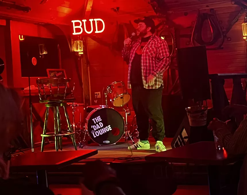 A person on stage with red lighting
