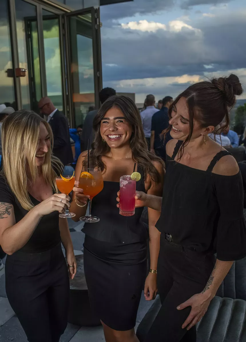 three women on rooftop bar