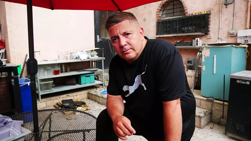 restaurant owner in kitchen with fire damage