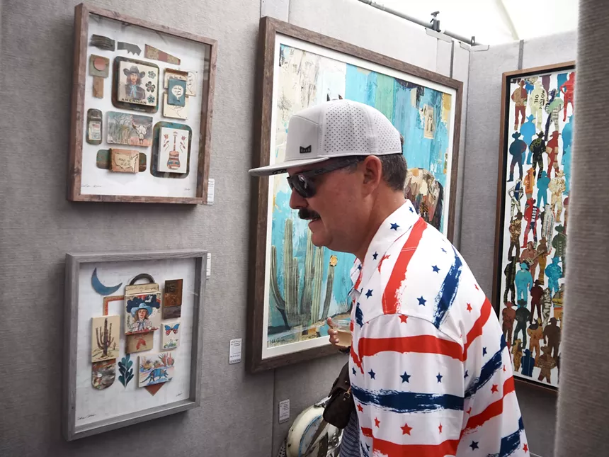 A man looks at cowboy themed art