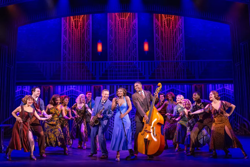 A musical theater ensemble performs a musical number.