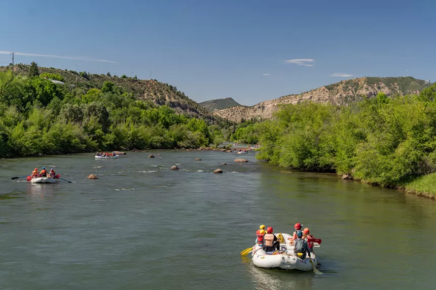 Several rafts on a Mild to Wild tour through the calm Lower Animas River