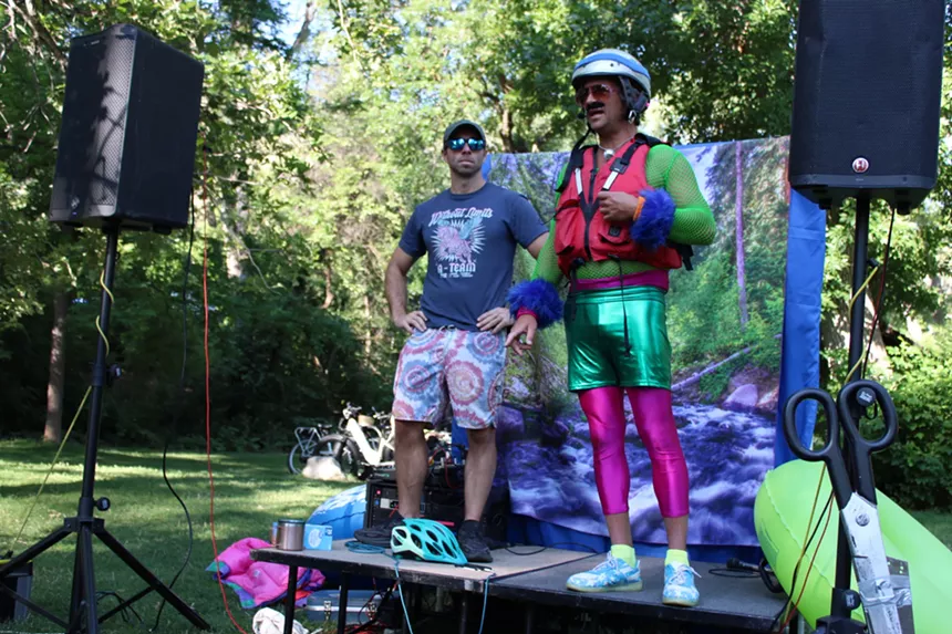 Two men stand on a stage.