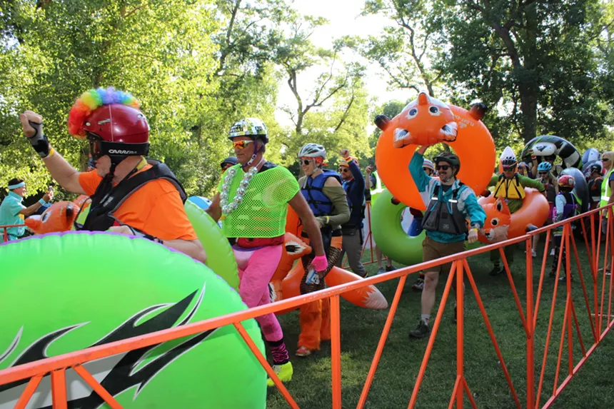 People with tubes walking.