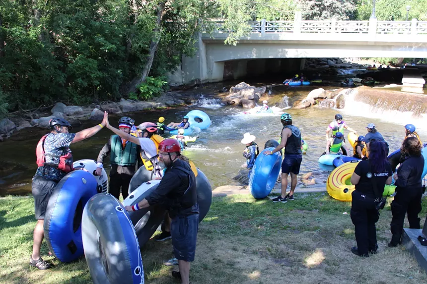 People with tubes getting out of the creek.