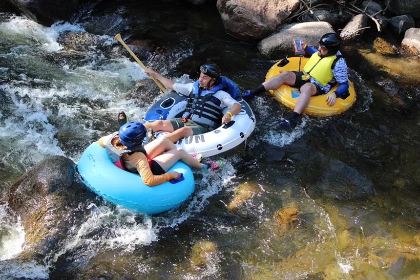 A group of people tube the Boulder Creek.