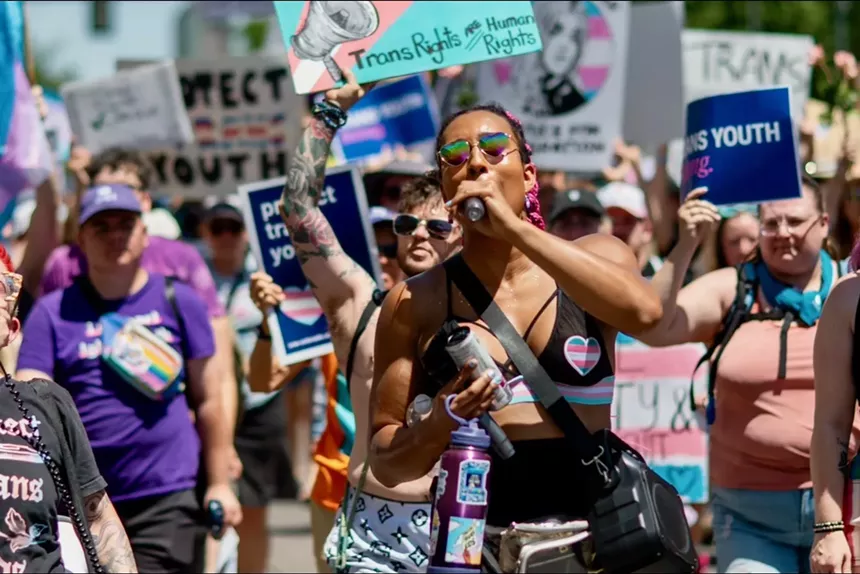 A woman holds up a sign at a protest