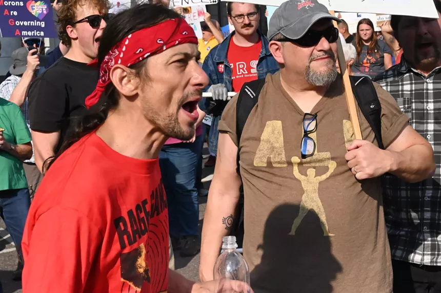 A protester yells.