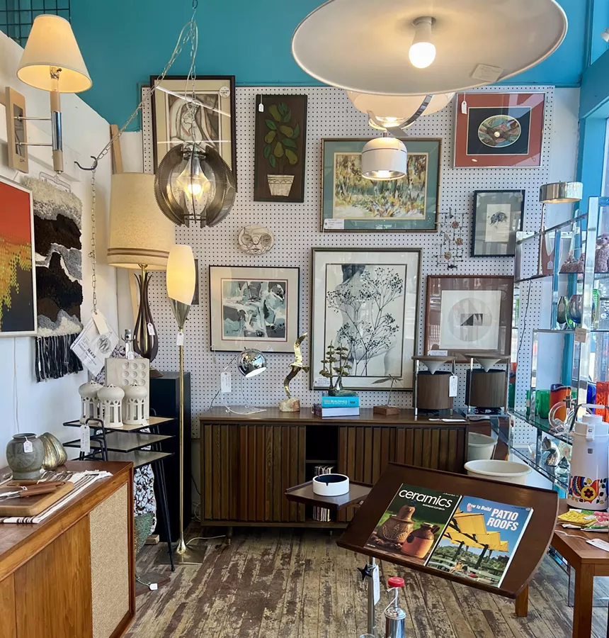 A blue-walled antique store packed with goods