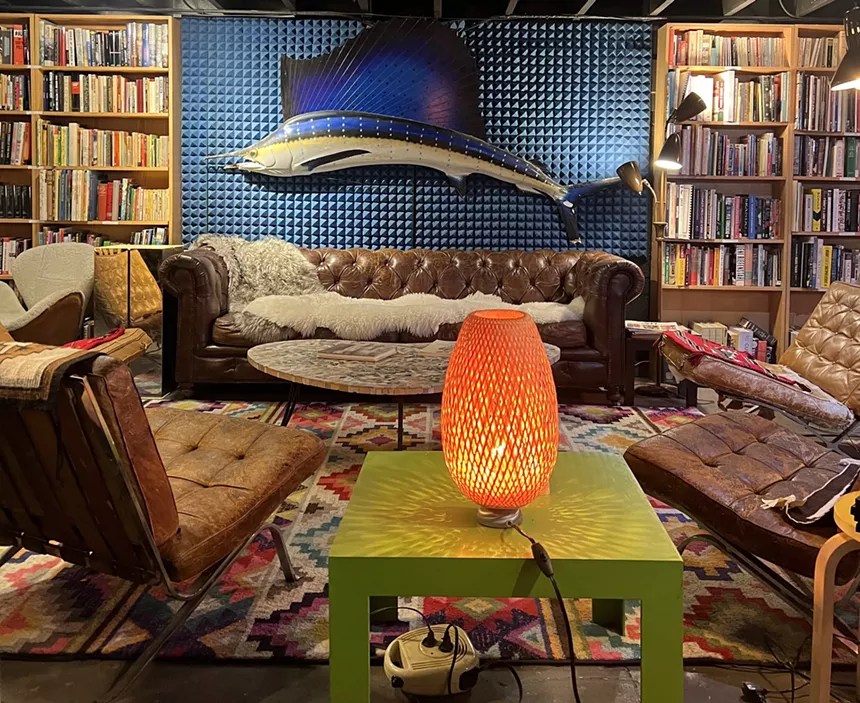 An antique store with a giant fish hanging on the wall