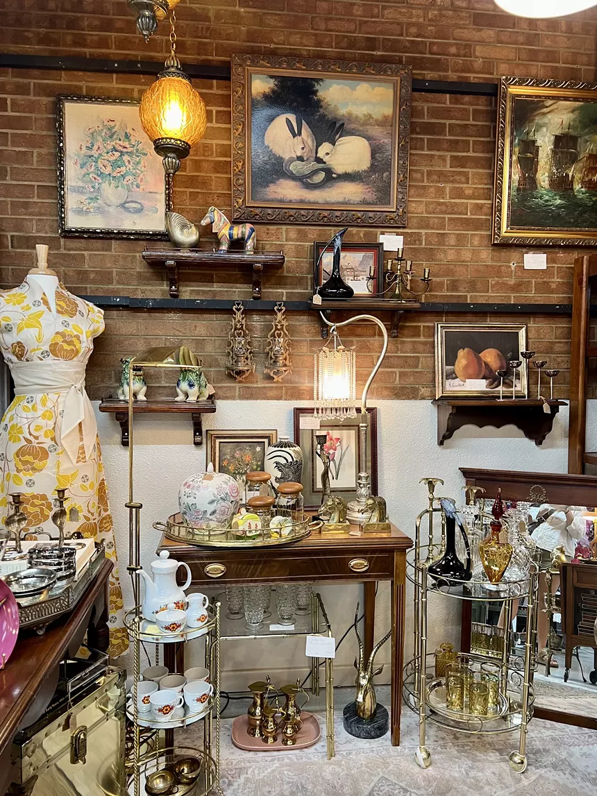 A packed antique store with a painting of bunnies