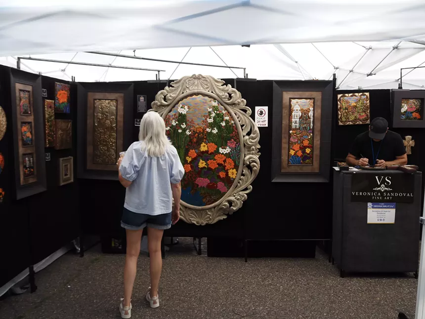 a woman looks at art
