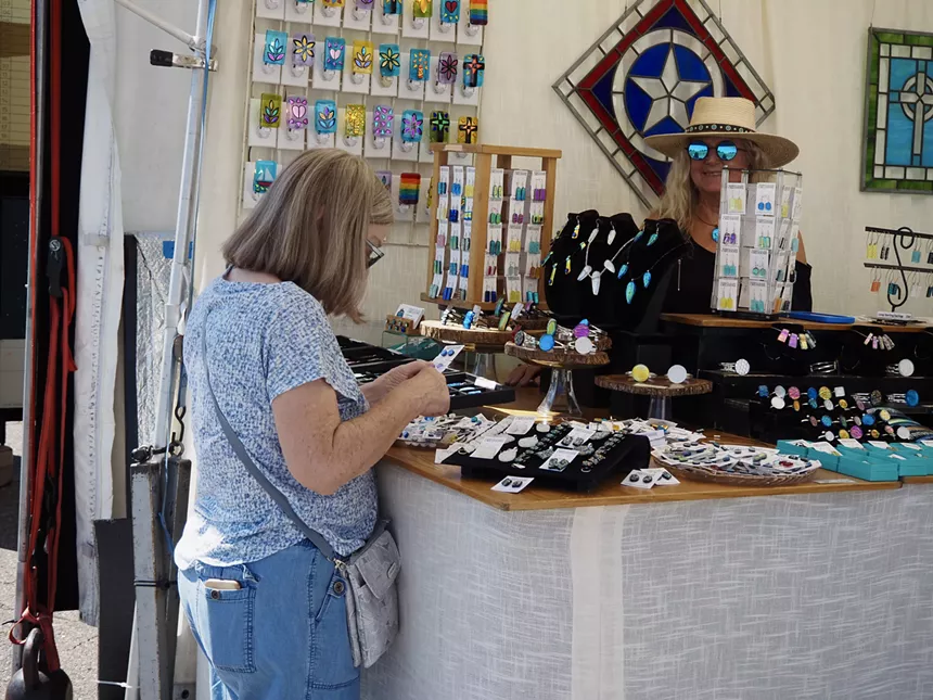 a woman looks at jewelry