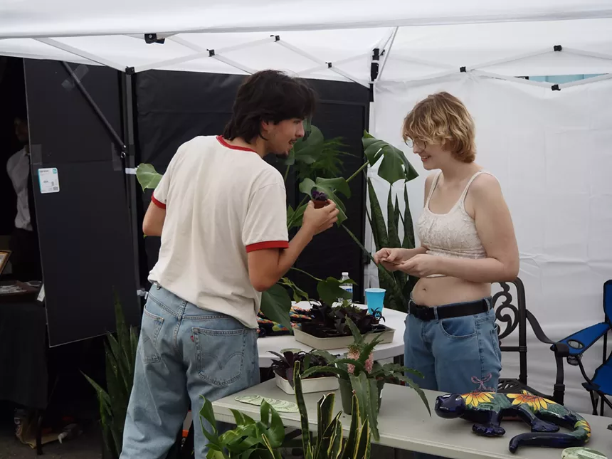 People holding plants and talking