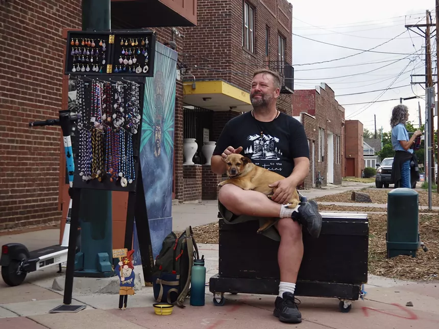 A man with a dog in his lap