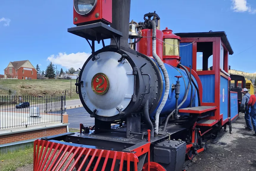 A vibrant steam locomotive at the Cripple Creek and Victor Narrow Gauge Railroad depot