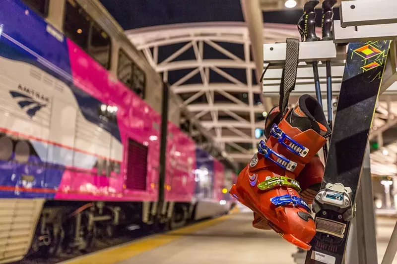 Skis and boots backdropped by the Winter Park Express at Union Station