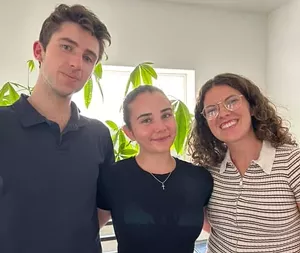 Three people pose for a photo