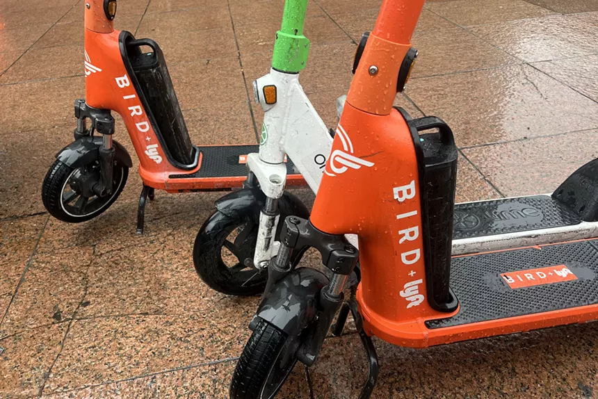 e-scooters sit out in the rain