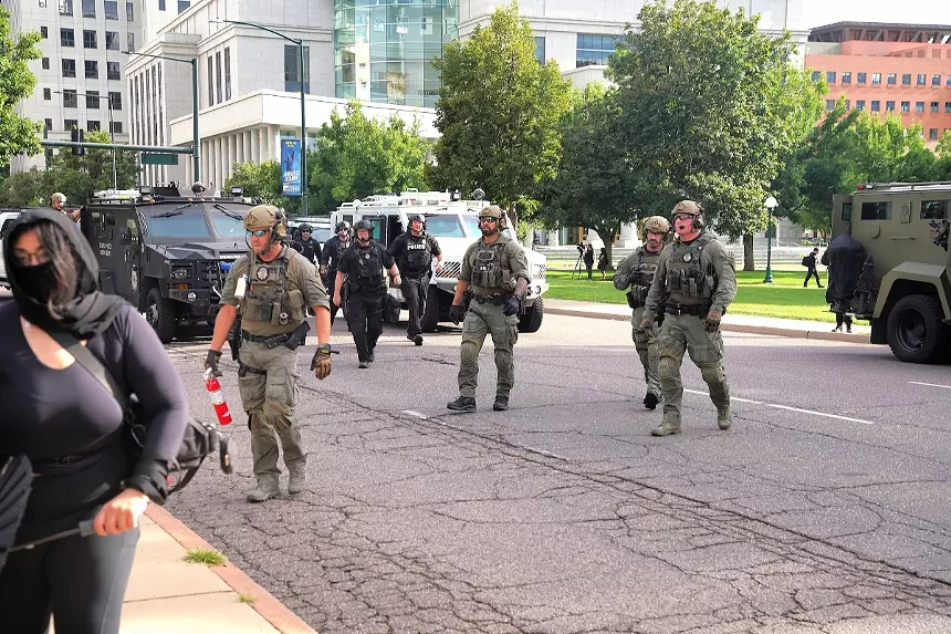 Law enforcement moves protesters.