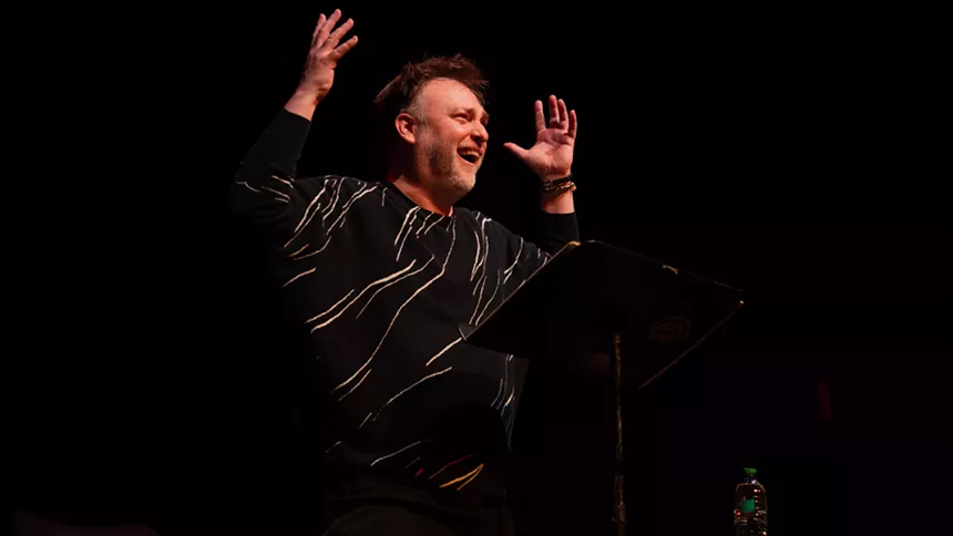 Man performs onstage.