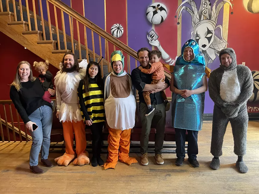 A group of actors pose as animals.