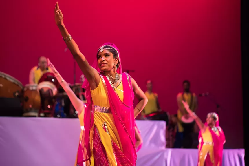 Dancers perform onstage.