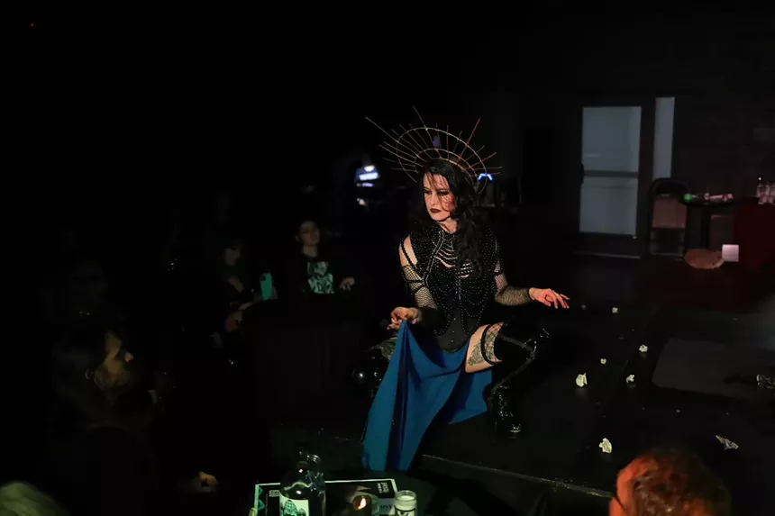 A person in burlesque costume poses