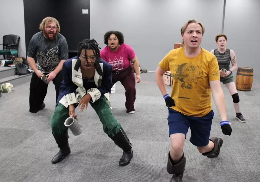 The cast practices a dance number.