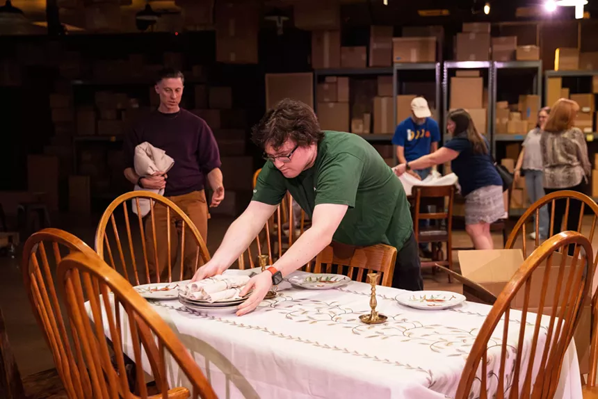 A man sets a table