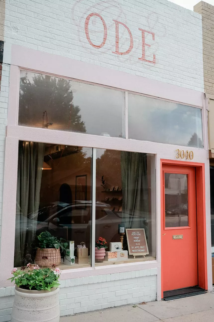 A pink and white storefront that says "ODE"
