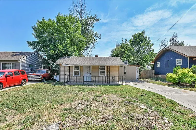 small home with grass lawn