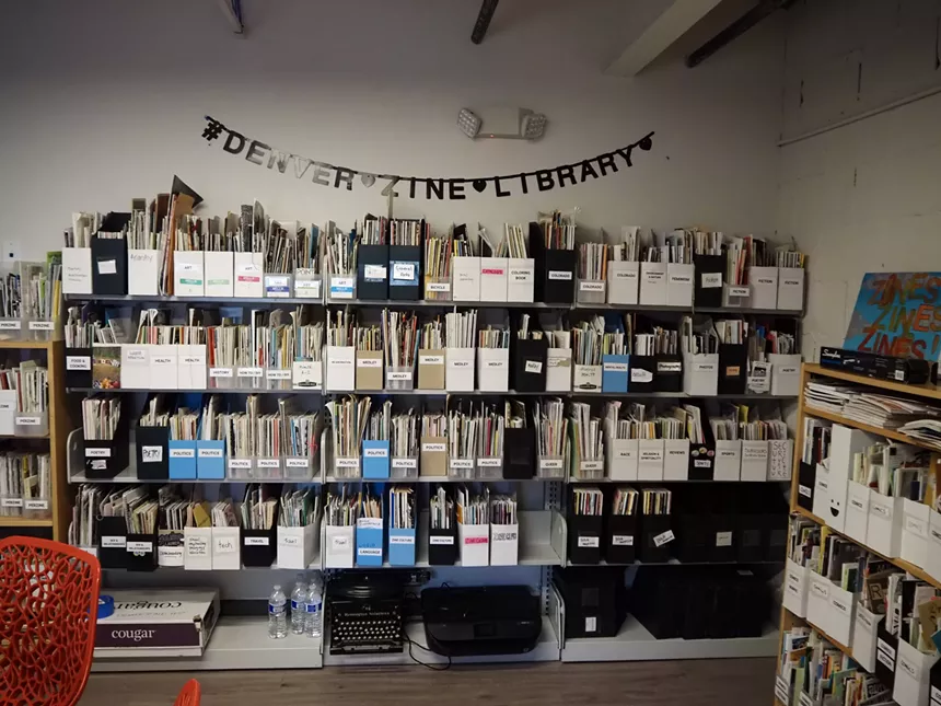 a room with shelves of zines in it