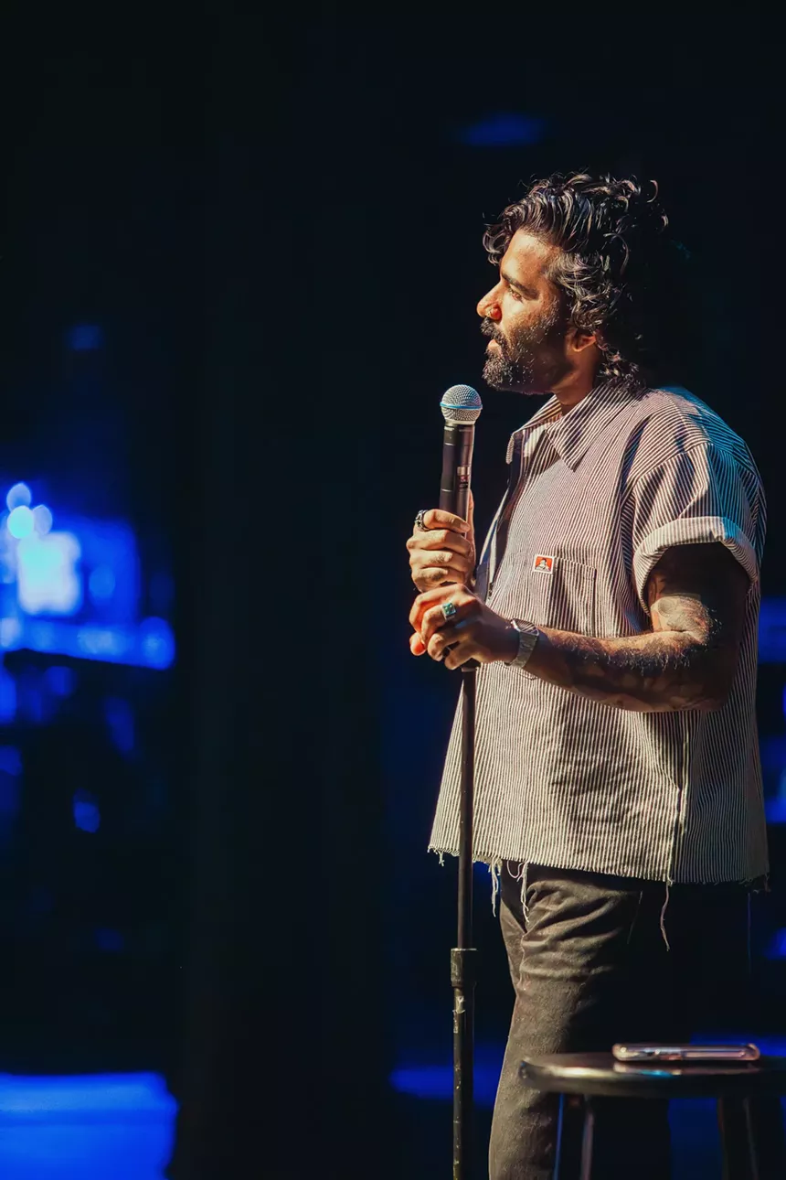 Comedian performs onstage.