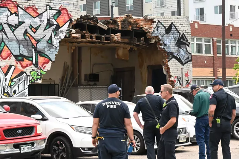 cops in front of collapsing building