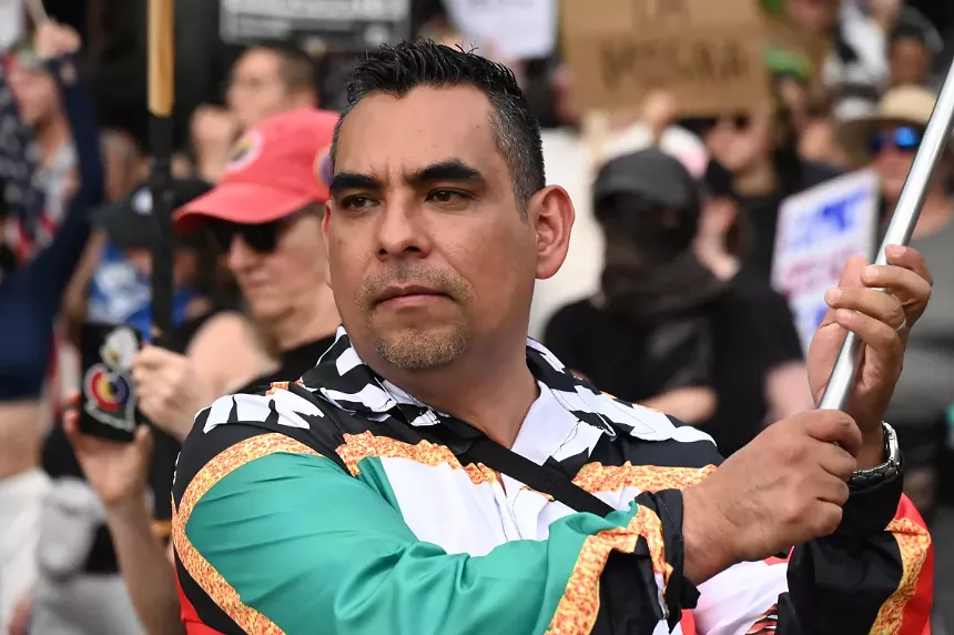 A man waives a Mexican flag.