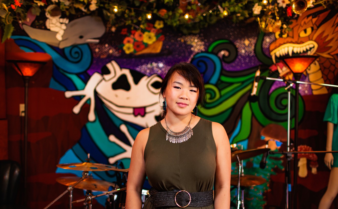 Andrea Hoang, co-founder of the Salt Lick Denver, stands in front of her mural at the collective's new studio.