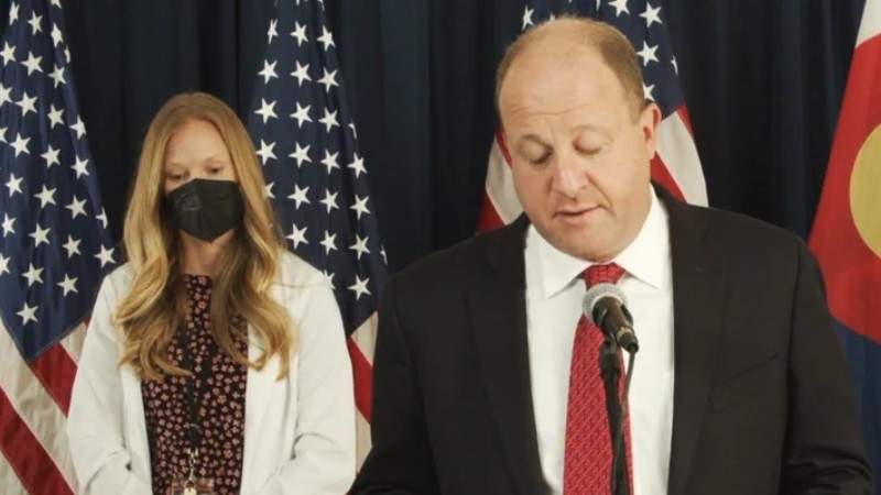 Dr. Rachel Herlihy and Governor Jared Polis as seen during a press conference last month.