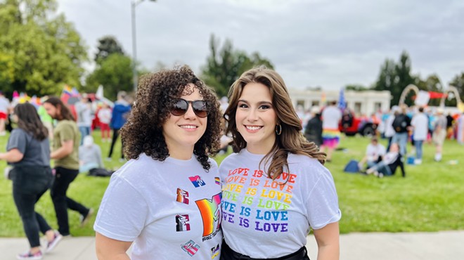 two women wear pride shirts