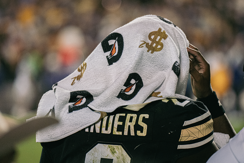 Image: Football player with towel on head
