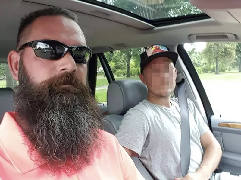 Image: two men in car, one with beard