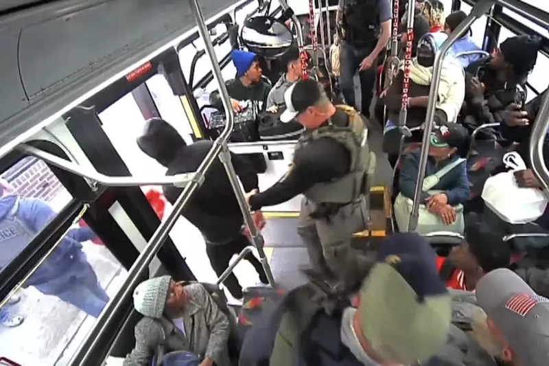 Image: A man is arrested on a bus.