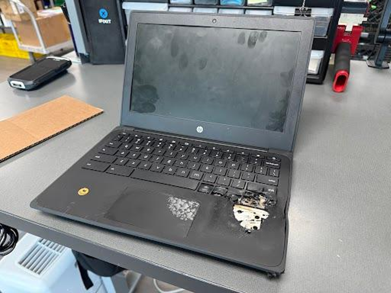 Image: A Chromebook laptop is burnt and melted after being tampered with in order to make the lithium batter ignite.