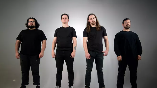 four men in black t shirts and jeans